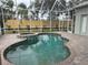 Enjoy the outdoors with a beautiful pool and attached spa surrounded by a screened enclosure and lush landscaping at 1206 86Th Nw Ct, Bradenton, FL 34209