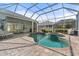 Spacious screened-in pool with an attached spa and paver patio at 1206 86Th Nw Ct, Bradenton, FL 34209