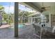 Covered patio with a table and chairs overlooking the screened-in pool at 1206 86Th Nw Ct, Bradenton, FL 34209