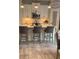 Island kitchen with white cabinets, quartz countertops, and pendant lighting at 5228 Bentgrass Way, Bradenton, FL 34211