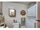 Clean bathroom with a white toilet, stacked washer/dryer, and storage space at 6428 Fleetwood Ct, North Port, FL 34287