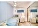 Cozy bedroom with twin bed, mirrored closet, and relaxing coastal decor at 6428 Fleetwood Ct, North Port, FL 34287