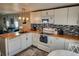 Bright kitchen with white cabinetry, stainless appliances, and wood countertops at 6428 Fleetwood Ct, North Port, FL 34287