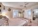 Calm main bedroom featuring a ceiling fan, comfortable bed, and ample storage space at 6428 Fleetwood Ct, North Port, FL 34287