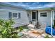 Charming patio area with lounge chairs and blue accents outside this cozy home at 6428 Fleetwood Ct, North Port, FL 34287