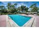 Community pool with ample seating and a shaded lounging area at 6428 Fleetwood Ct, North Port, FL 34287