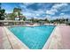 Community swimming pool features clear blue water, lounge chairs, and lush landscaping at 6428 Fleetwood Ct, North Port, FL 34287