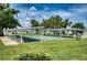 Community shuffleboard courts surrounded by manicured lawn and sun shade structures for comfortable play at 6428 Fleetwood Ct, North Port, FL 34287