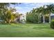 Luxury home with a manicured lawn and palm trees at 3482 Flamingo Ave, Sarasota, FL 34242