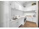 Bright laundry room with white cabinets, marble countertops, and modern appliances at 3482 Flamingo Ave, Sarasota, FL 34242