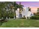 Two-story home exterior with lush lawn and sunset views at 3482 Flamingo Ave, Sarasota, FL 34242