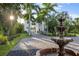 Elegant home entrance with a fountain and palm trees at 3482 Flamingo Ave, Sarasota, FL 34242