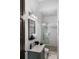 Modern bathroom with glass shower, gray vanity, and patterned floor at 3482 Flamingo Ave, Sarasota, FL 34242