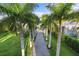 Long driveway lined with palm trees leading to a home at 3482 Flamingo Ave, Sarasota, FL 34242