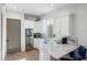 White kitchen with stainless steel appliances and marble countertops at 3482 Flamingo Ave, Sarasota, FL 34242