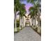 Driveway entrance to the house at sunset with palm trees at 3482 Flamingo Ave, Sarasota, FL 34242