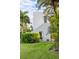 White stucco house with lush landscaping, a walkway, and palm trees at 3482 Flamingo Ave, Sarasota, FL 34242