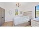 Bright bedroom with a queen bed and elegant chandelier at 3482 Flamingo Ave, Sarasota, FL 34242