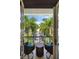 Private balcony with wicker chairs and a table, overlooking a garden at 3482 Flamingo Ave, Sarasota, FL 34242