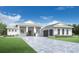 Two-story home with white exterior and a three-car garage at 17938 Palmiste Dr, Bradenton, FL 34202