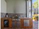 Outdoor kitchen with grill, sink, and mini-fridge at 1206 86Th Nw Ct, Bradenton, FL 34209