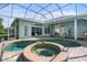 Inviting pool and spa area with a covered patio at 1206 86Th Nw Ct, Bradenton, FL 34209