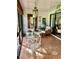 Sunroom features a glass-top table, wicker chairs, and terracotta tile floor at 3500 El Conquistador Pkwy # 307, Bradenton, FL 34210