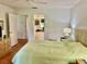 Spacious bedroom with light green bedding and access to a patio at 3500 El Conquistador Pkwy # 307, Bradenton, FL 34210