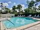 Refreshing community pool area with surrounding lounge chairs at 3500 El Conquistador Pkwy # 307, Bradenton, FL 34210