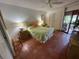 Bright bedroom with tiled floors, a double bed, and access to a patio at 3500 El Conquistador Pkwy # 307, Bradenton, FL 34210