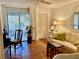 Living room with beige sofa, wooden nesting tables, and tiled floors at 3500 El Conquistador Pkwy # 307, Bradenton, FL 34210