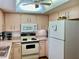 Well-equipped kitchen with white cabinets and appliances at 3500 El Conquistador Pkwy # 307, Bradenton, FL 34210