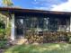 Exterior view showing a condo with a screened porch and landscaping at 3500 El Conquistador Pkwy # 307, Bradenton, FL 34210