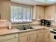 Kitchen features ample counter space and a double sink at 3500 El Conquistador Pkwy # 307, Bradenton, FL 34210