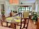 Dining area with glass-top table and wicker chairs at 3500 El Conquistador Pkwy # 307, Bradenton, FL 34210