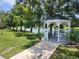 Charming gazebo overlooking a serene lake with benches at 6428 Fleetwood Ct, North Port, FL 34287