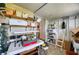 Unfinished storage/utility room with shelves and work tables at 6428 Fleetwood Ct, North Port, FL 34287