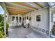 Covered patio with ceiling fan and seating area at 6428 Fleetwood Ct, North Port, FL 34287