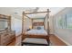 Bedroom with bamboo canopy bed and built-in closet at 549 Sloop Ln, Longboat Key, FL 34228