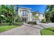 Two-story home with double door entry and brick driveway at 549 Sloop Ln, Longboat Key, FL 34228