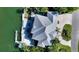 Aerial view of a waterfront home with a metal roof and private dock at 549 Sloop Ln, Longboat Key, FL 34228
