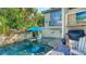 Relaxing pool area with outdoor kitchen and comfortable seating at 549 Sloop Ln, Longboat Key, FL 34228