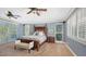 Spacious bedroom with a large bed, plenty of natural light, and plantation shutters at 549 Sloop Ln, Longboat Key, FL 34228