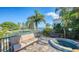 Waterfront patio with a spa, seating area, and stunning water views at 549 Sloop Ln, Longboat Key, FL 34228