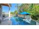 Inviting pool area with stone accents, lush landscaping, and comfortable seating at 549 Sloop Ln, Longboat Key, FL 34228