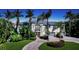 Luxury waterfront home with palm trees and circular driveway at 549 Sloop Ln, Longboat Key, FL 34228