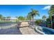Spacious patio with seating area and spa overlooking the water at 549 Sloop Ln, Longboat Key, FL 34228