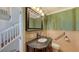 Elegant bathroom with dark vanity, decorative mirror, and updated fixtures at 549 Sloop Ln, Longboat Key, FL 34228