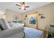 Living room with beige couch and large window at 1122 Seminole Sky Dr, Ruskin, FL 33570