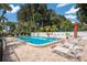 Community pool with lounge chairs and umbrellas at 3705 E Bay Dr # 115, Holmes Beach, FL 34217